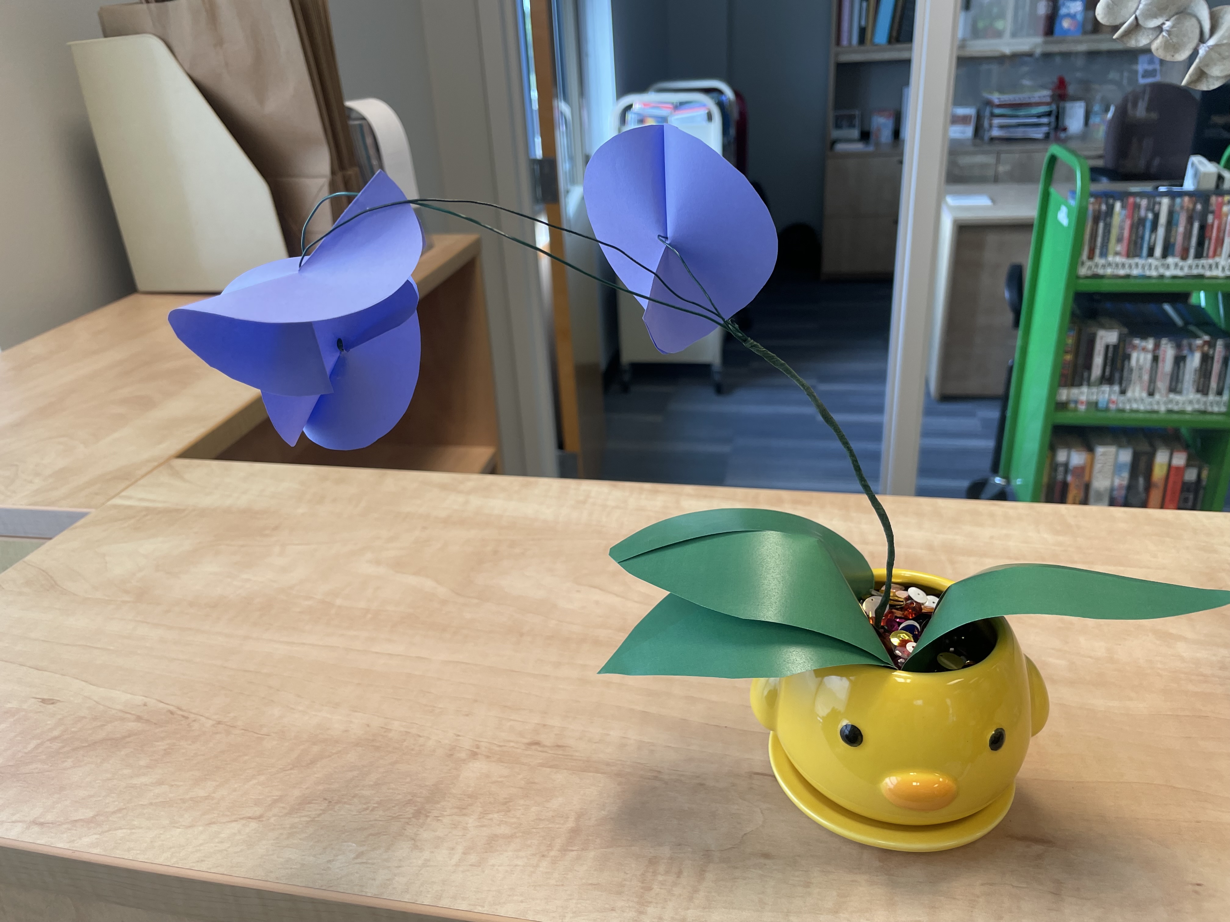 Paper orchids in a yellow planter