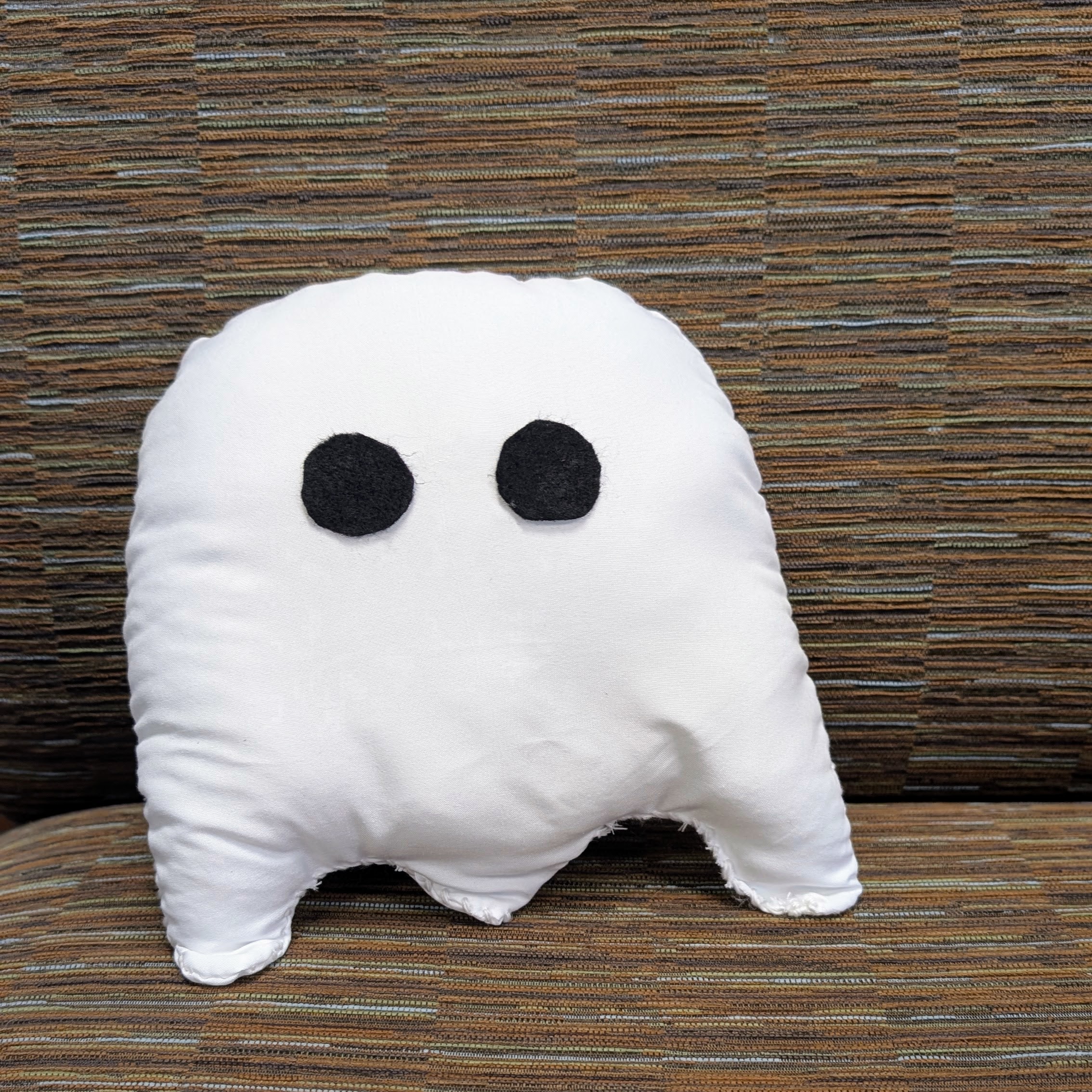 A ghost shaped pillow sewn from fleece