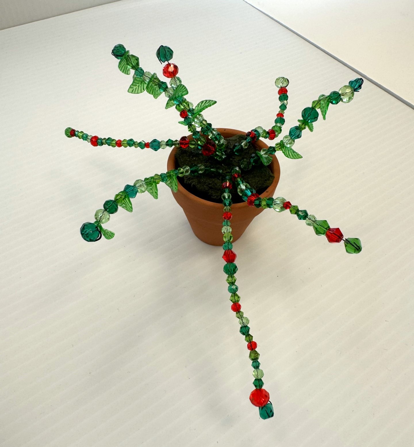 Spider plant made using beads and placed in a terracotta pot