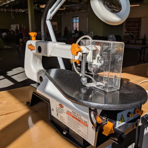 A scroll saw on a wooden table