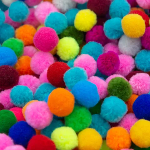 A pile of colorful cotton pom-poms