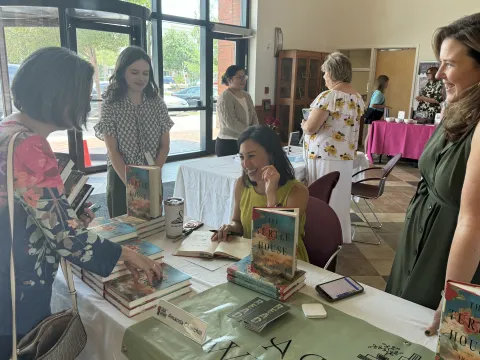 Author Amanda Churchill signing a book in the Library lobby at the 2024 event