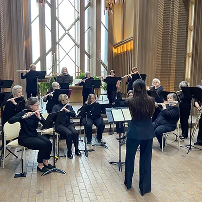 A group of flautists playing in a chapel