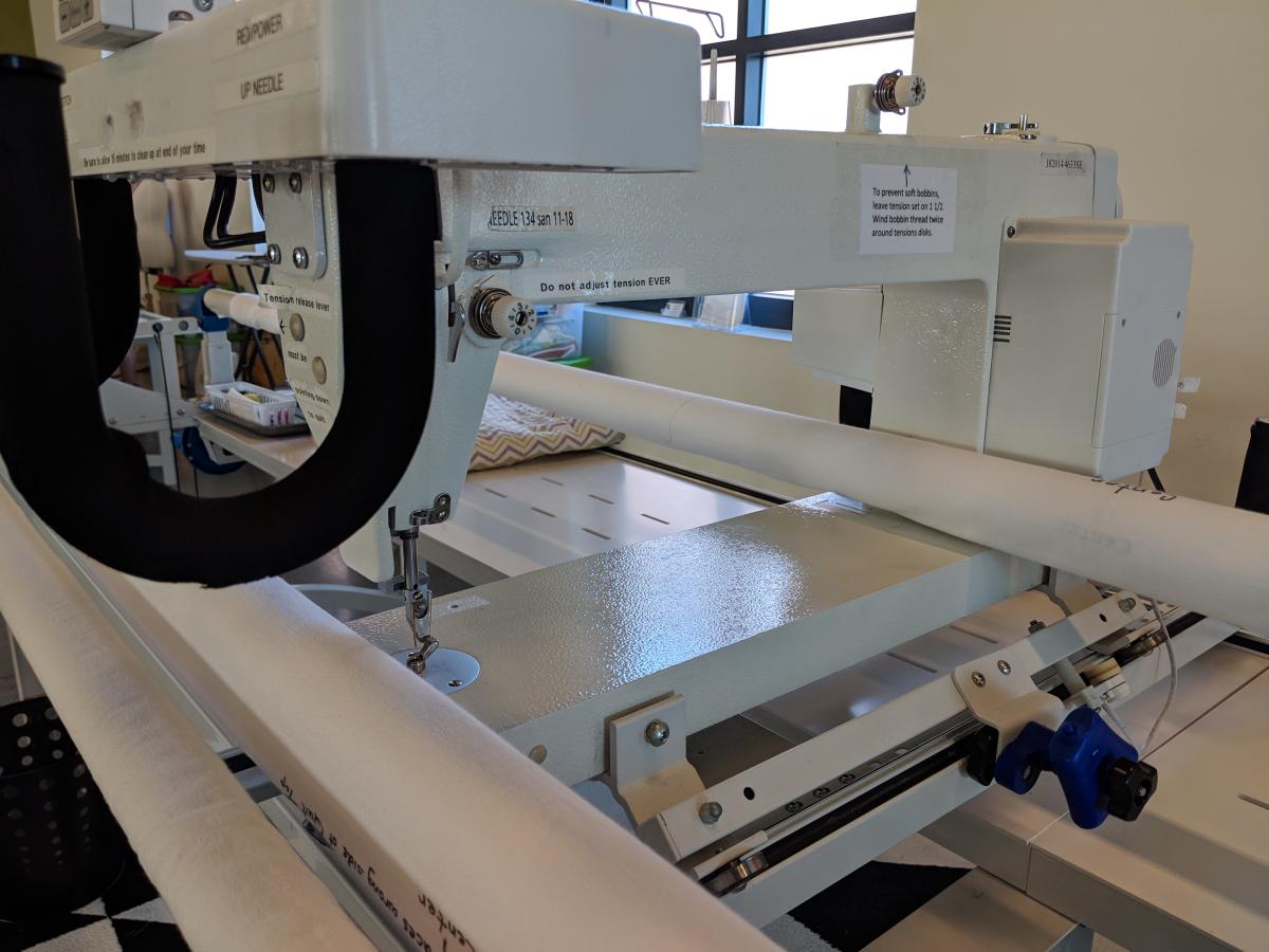 A close-up of a Janome quilting star quilting machine frame